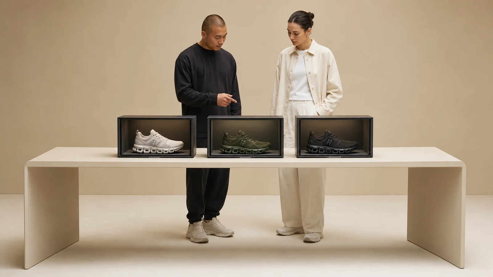 Designers comparing three dimensional footwear twins inside a bounded Reality Relay chamber